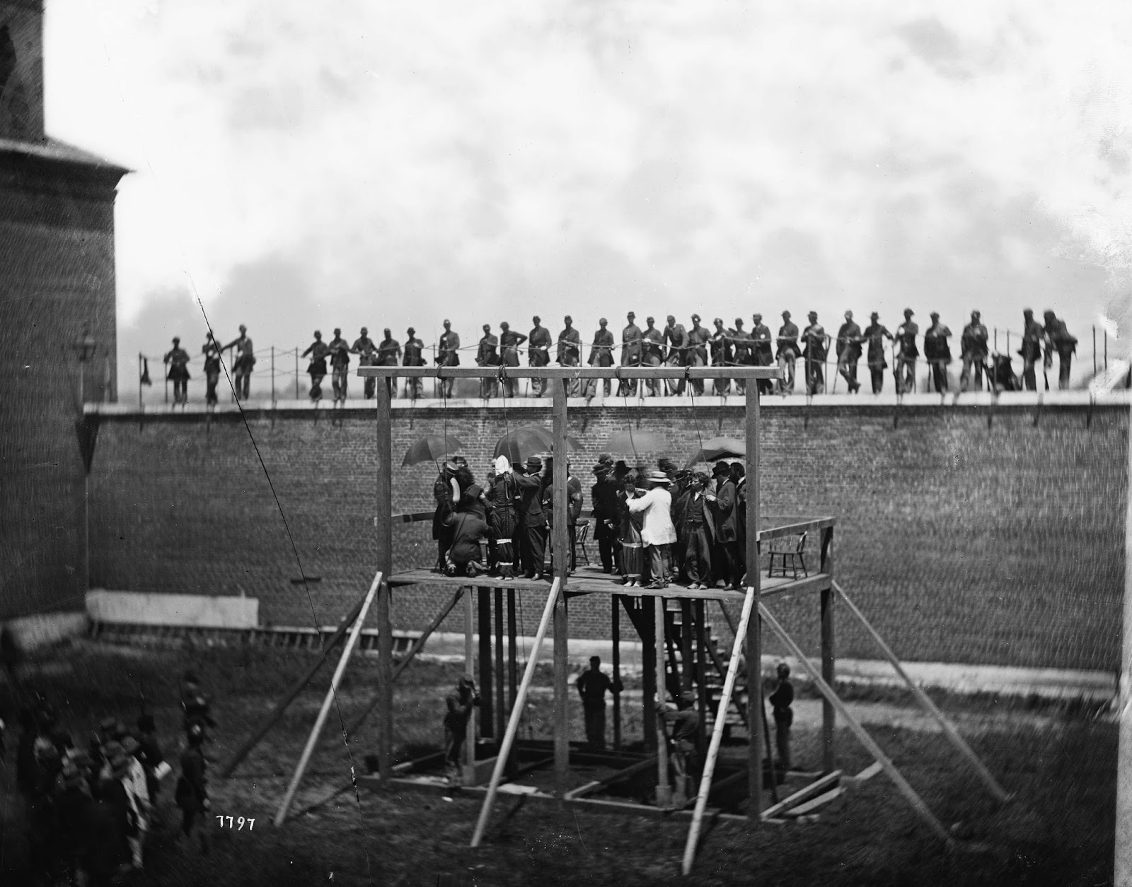 Adjusting the ropes for hanging the conspirators. White cloth was used to bind their arms to their sides, and their ankles and thighs together.